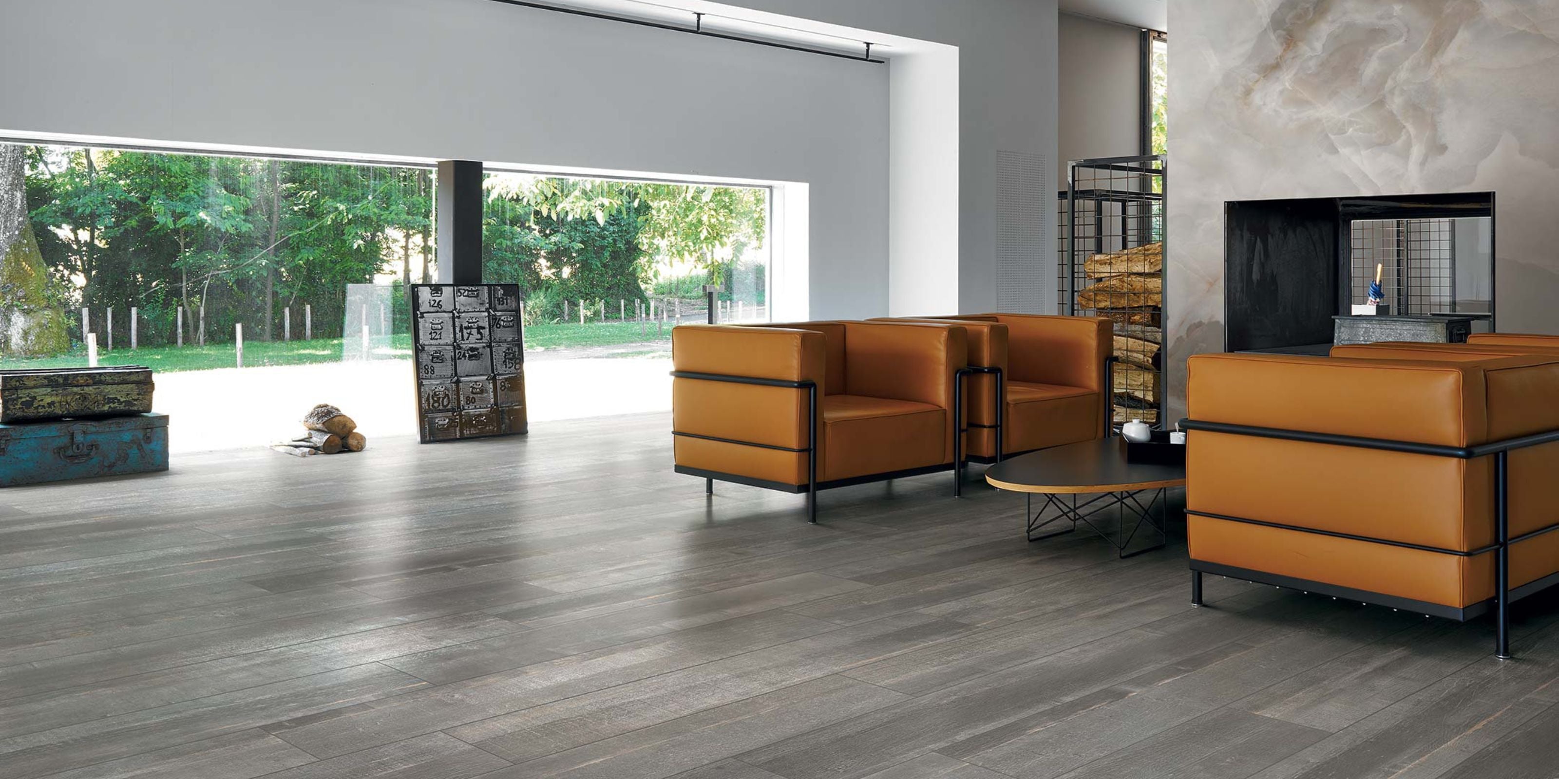 large living room with dark grey matt wood effec porcelain tile flooring