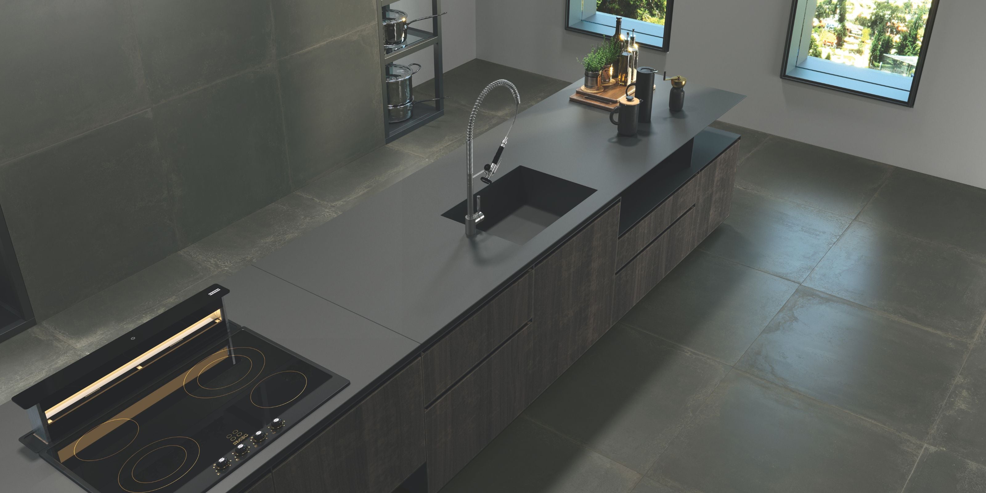 Bird's eye view of a sleek kitchen with a large central island. Floor and walls covered by matt black stone effect porcelain kitchen floor and wall tiles