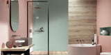 Large luxury bathroom with walk in shower and bathtub with green wall tiles and pink wall tiles