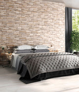 bedroom with natural stone split face wall tiles behind bed