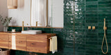 Deep green polished subway wall tiles in bathroom with walk-in shower and large vanity