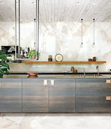 Modern kitchen with large island and large-format white-cream onyx effect polished porcelain wall tiles