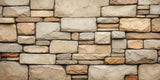 wall made up of many beige bricks in a variety of sizes arranged in a modular fashion