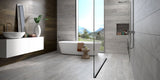 Contemporary spa-style bathroom with grey stone effect porcelain bathroom floor and wall tiles, wall-mounted vanity, freestanding bathtub, and built-in shower niche 