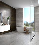 Sleek minimalist bathroom design with grey stone effect porcelain bathroom floor and wall tiles banner, wood effect accent wall, freestanding tub, and floor-to-ceiling window 
