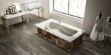 luxury spa-like bathroom with large freestanding bathtub and grey wood effect porcelain bathroom floor tiles