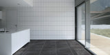 empty kitchen with black porcelain stone effect floor tiles and vertical white subway wall tiles