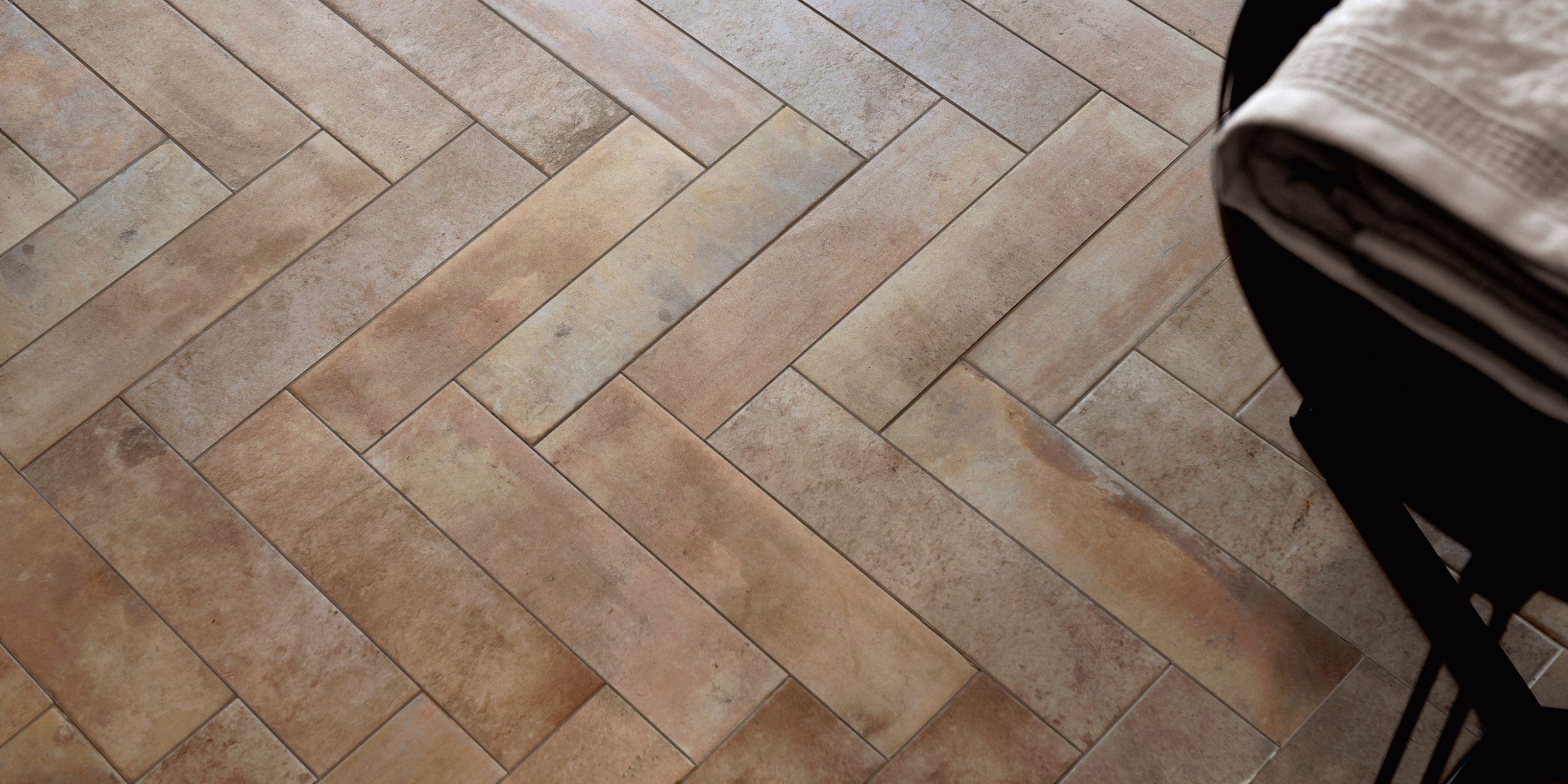 close up of matt brown natural stone effect porcelain subway floor tiles