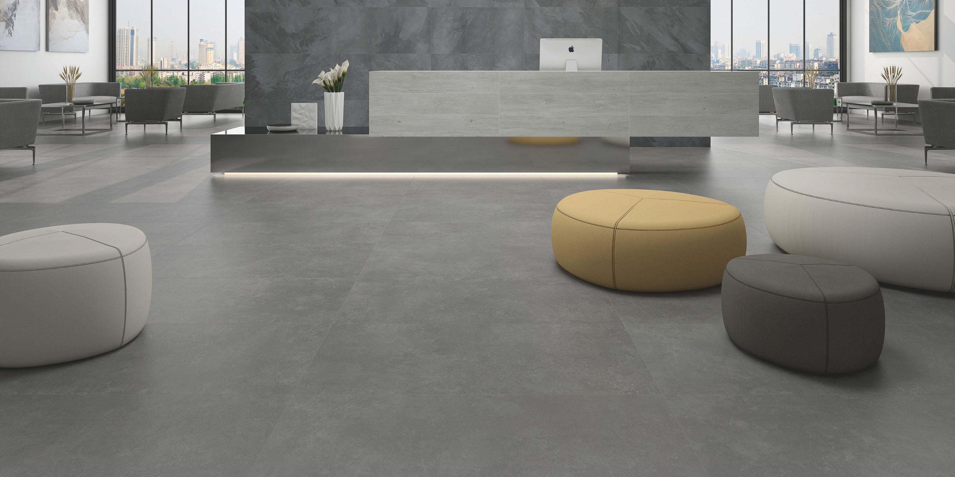 sleek indoor reception area whith large matt dark grey stone effect porcelain floor tiles