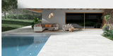 Garden patio and pool area with matt white stone-effect 20mm outdoor porcelain tiles