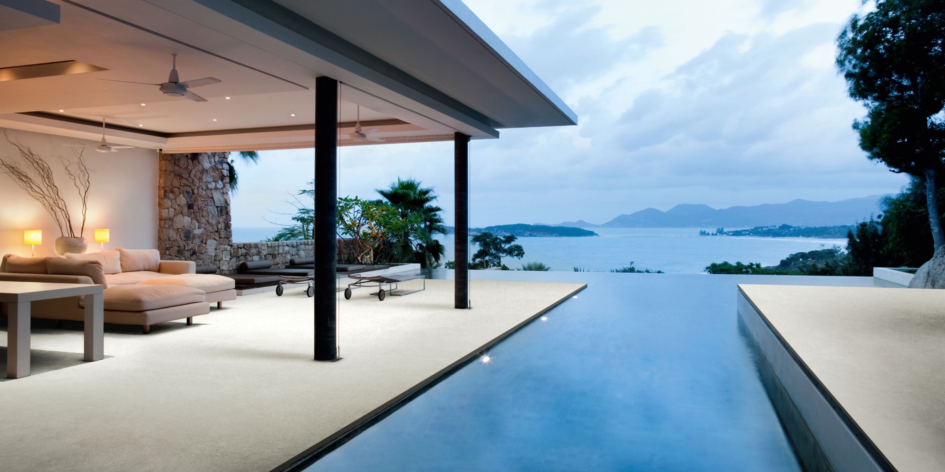 luxury indoor/outdoor patio area with pool and beige stone-effect 20mm outdoor porcelain floor tiles