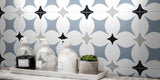 close-up of bathroom wall tiled with a white blue, grey, and black patterned ceramic victorian bathroom wall tile