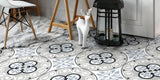 floor tiled with white, grey, blue and black victorian style patterned floor tiles